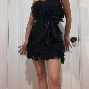 Black mini dress from GUESS. Frills, and satin tie around.